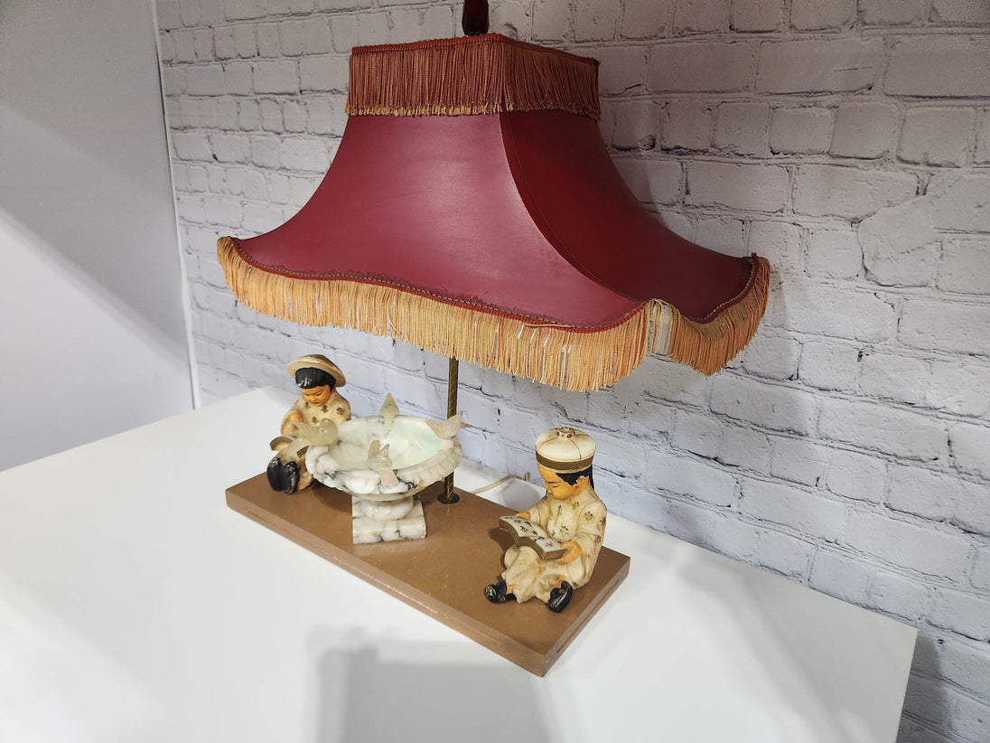 Kitsch vintage chinese lamp 1950's lampKitsch vintage chinese lamp lamp in the shape of a made in the 50s /60This vintage beauty has marble sculpted kids, birds and water fountain !Cool center piece decorChas Vintage ShopKitsch vintage chinese lamp 1950'