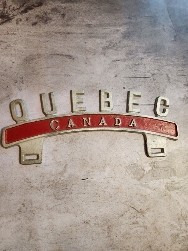 Vintage QUEBEC CANADA License Plate Topper  new old stock never been oVintage License Plate Topper Quebec Canada  License Plate Topper new old stockThis fine exemple of a vintage topper was made in the 1940's in Montreal by Farrell ManChas Vintage ShopVintage QUEBEC CANADA License Plate Topper