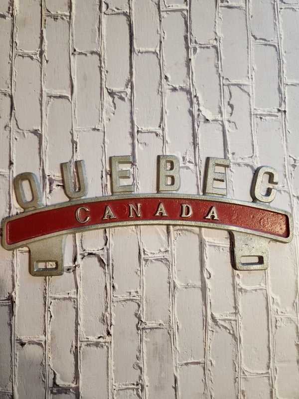 Vintage QUEBEC CANADA License Plate Topper  new old stock never been oVintage License Plate Topper Quebec Canada  License Plate Topper new old stockThis fine exemple of a vintage topper was made in the 1940's in Montreal by Farrell ManChas Vintage ShopVintage QUEBEC CANADA License Plate Topper