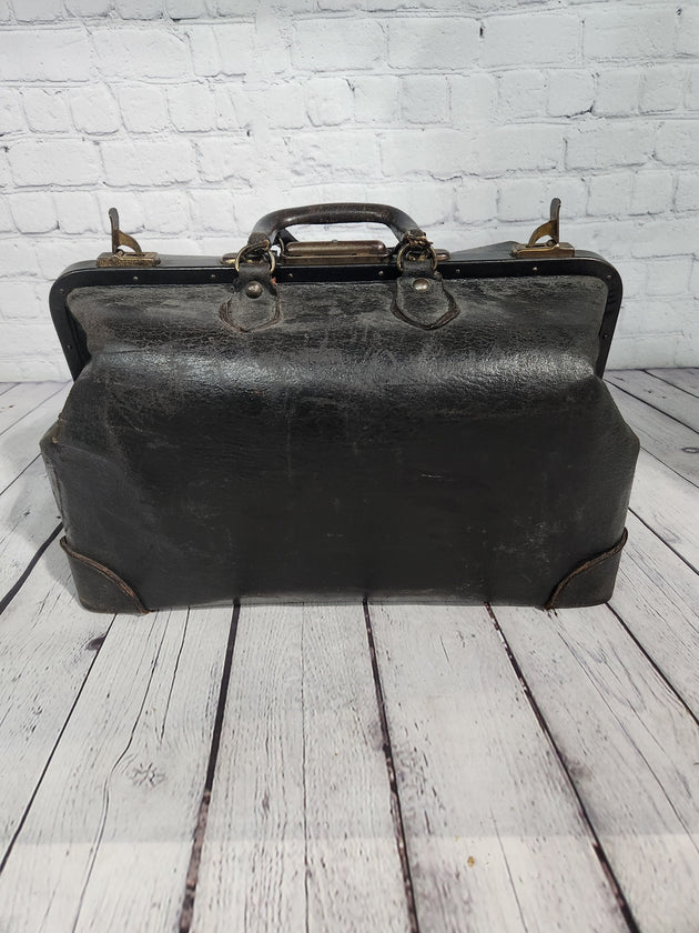 Vintage black cowhide doctor leather bag  antique doctor bag medical lVintage black cowhide Doctor leather bag Antique doctor bag Medical leatherbagYes there are condition issues, but that's what makes it so charming and a great
decoraChas Vintage ShopVintage black cowhide doctor leather bag antique doctor bag medical leatherbag classic md leather bag classic doctor leather bag