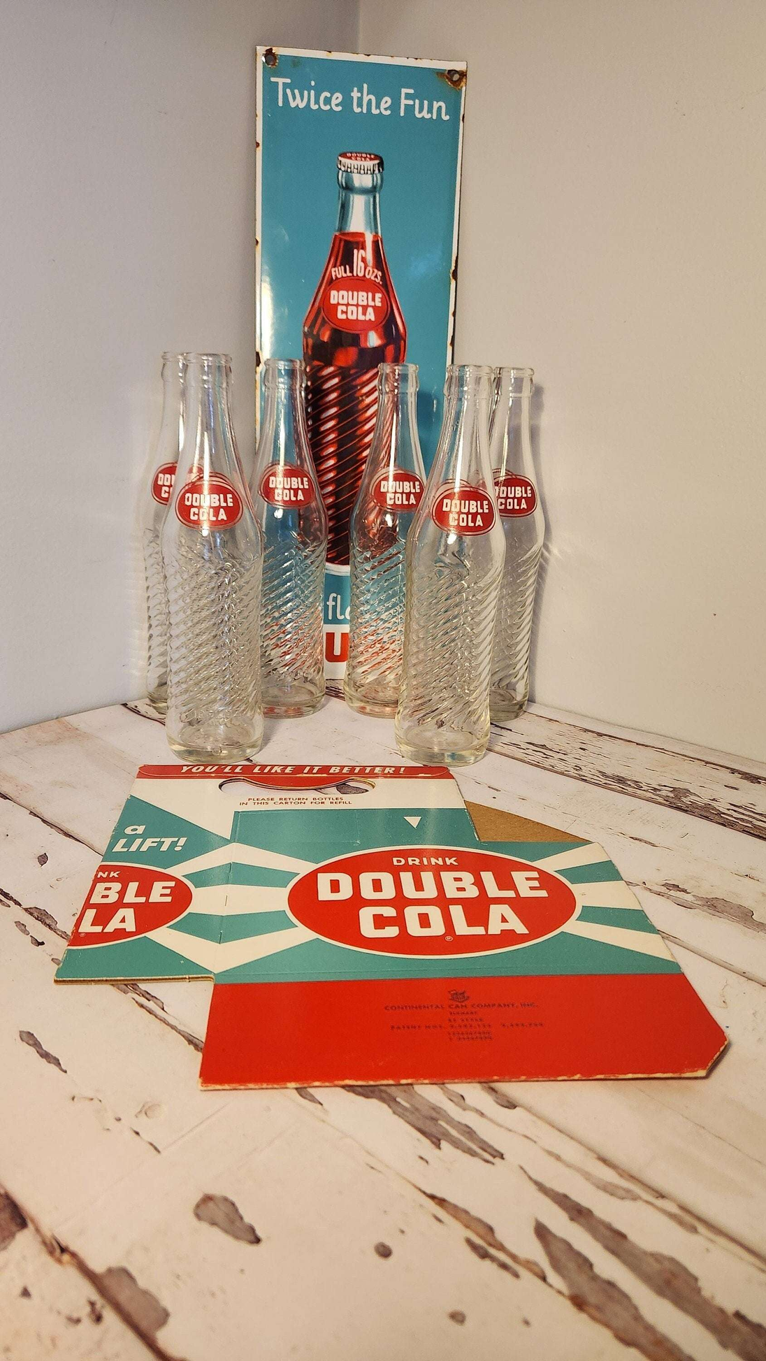 Bring back the good times with this  double cola collector six pack anRelive the nostalgia of the classic Double Cola with this amazing collector set!This set includes a porcelain Double Cola sign, six Double Cola bottles, and a DoubleChas Vintage Shopdouble cola collector