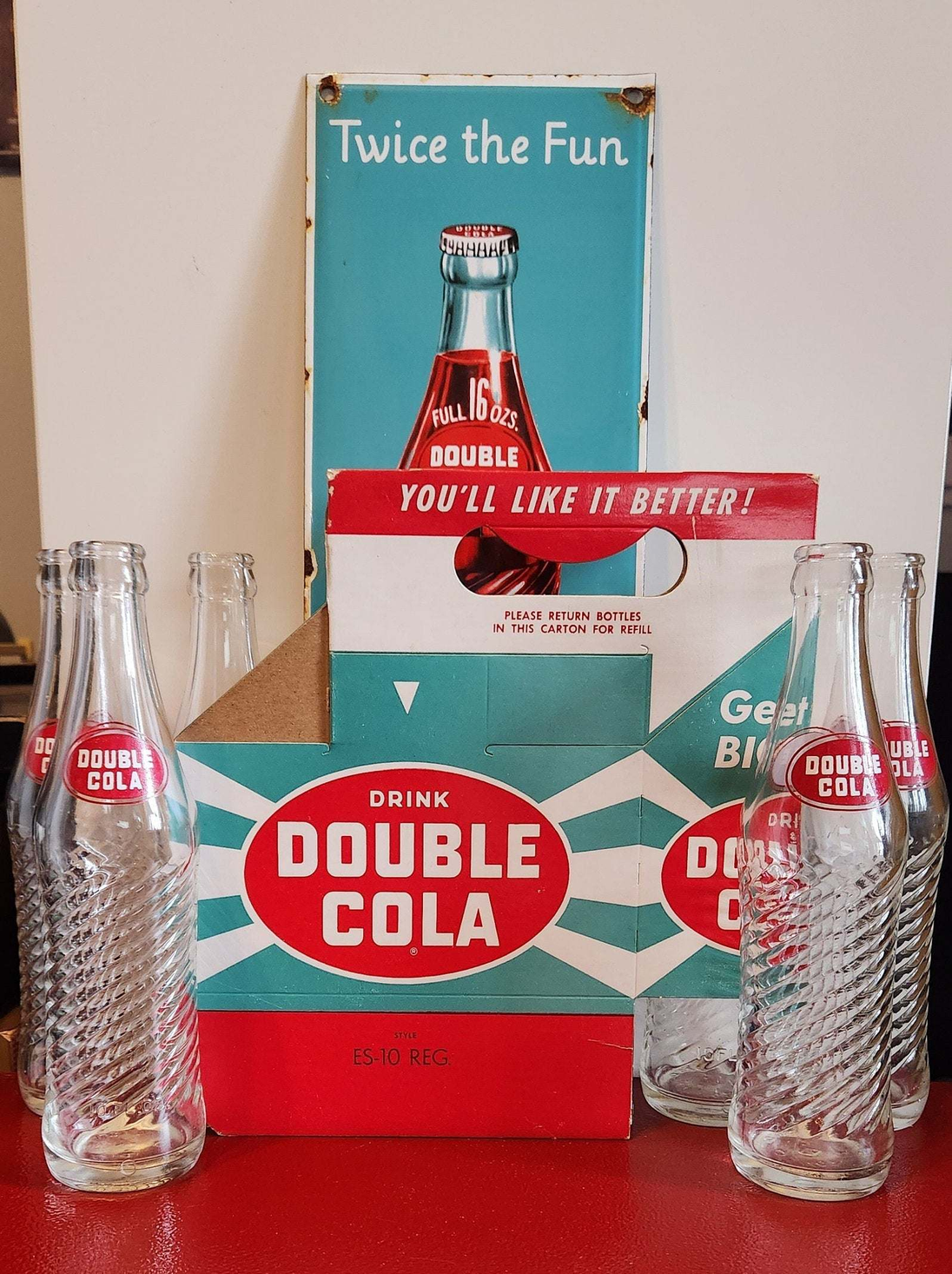 Bring back the good times with this  double cola collector six pack anRelive the nostalgia of the classic Double Cola with this amazing collector set!This set includes a porcelain Double Cola sign, six Double Cola bottles, and a DoubleChas Vintage Shopdouble cola collector