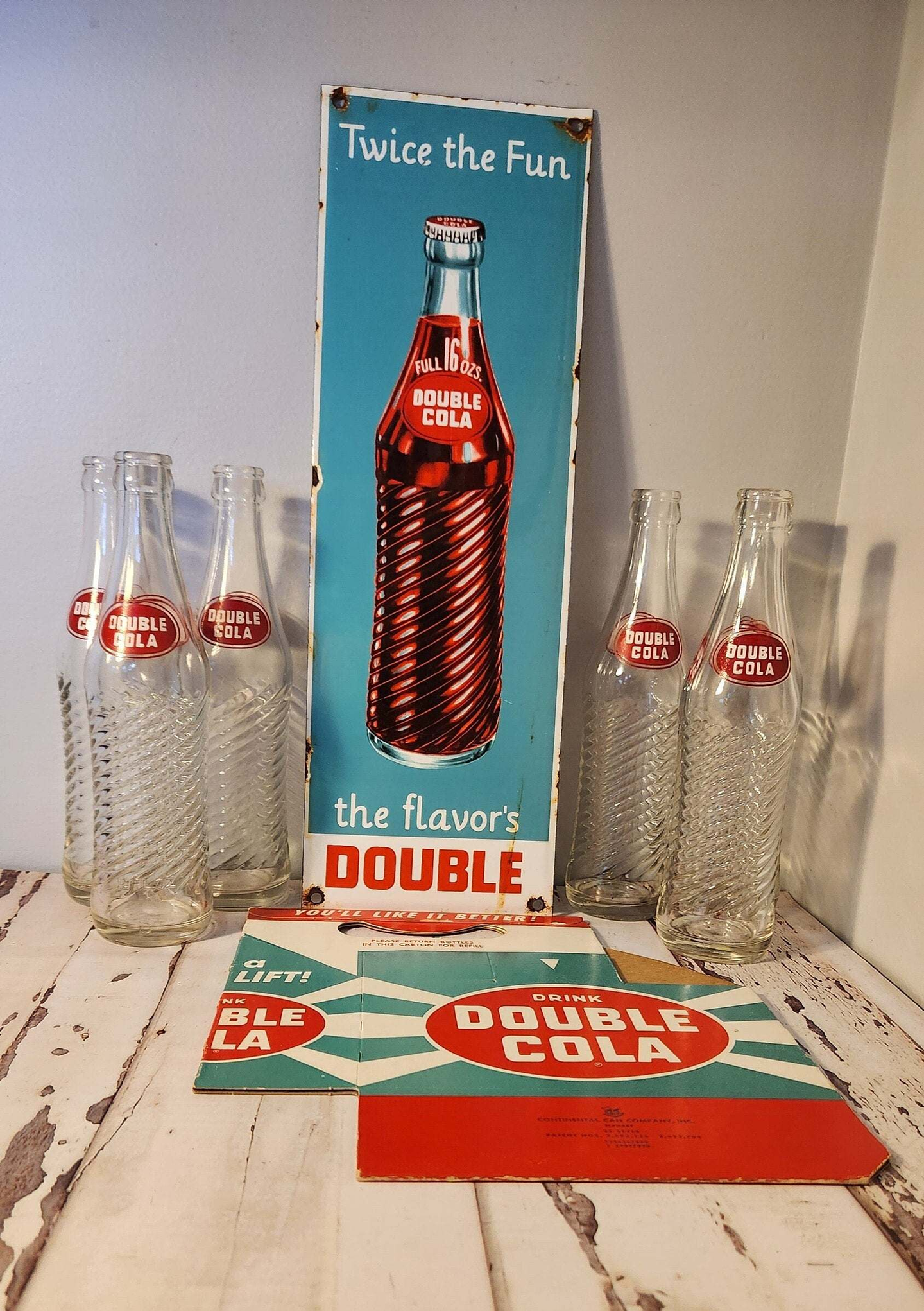 Bring back the good times with this  double cola collector six pack anRelive the nostalgia of the classic Double Cola with this amazing collector set!This set includes a porcelain Double Cola sign, six Double Cola bottles, and a DoubleChas Vintage Shopdouble cola collector