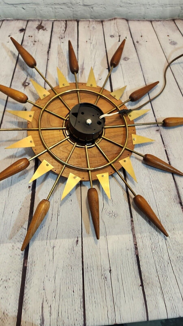 Vintage mid century  sunburst 1960s wall clock, 24" inches real not reAdd a touch of vintage flair to your home decor with this stunning 1960s sunburst wall clock. The clock features a charming starburst design, with a round shape and Chas Vintage ShopVintage mid century sunburst 1960s wall clock, 24" inches real