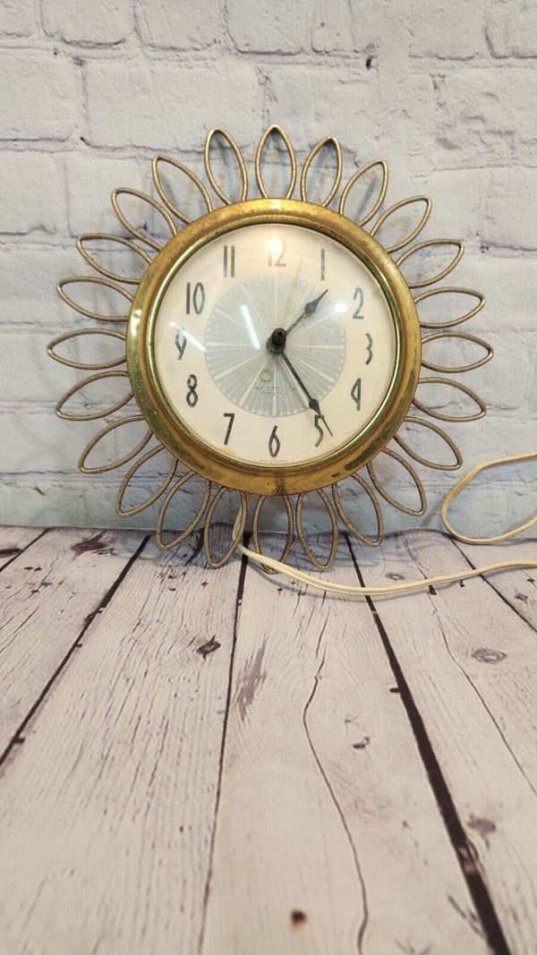 Vintage mid century  sunburst 1960s westclox wall clock, 11" inches. rAdd a touch of retro charm to your home with this vintage mid-century Westclox wall clock. The clock features a round shape with a gold-tone metal frame sunburst desChas Vintage ShopVintage mid century sunburst 1960s westclox wall clock, 11" inches