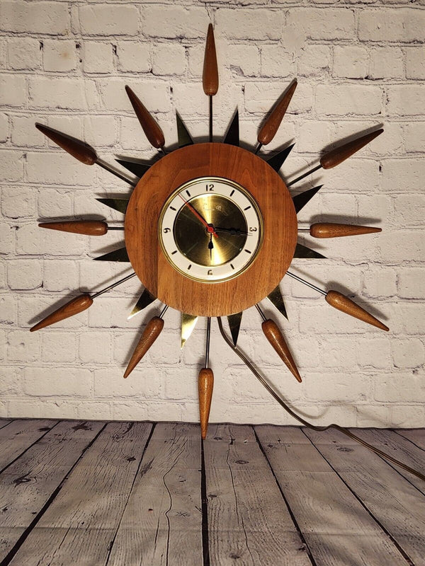 Vintage mid century  sunburst 1960s wall clock, 24" inches real not reAdd a touch of vintage flair to your home decor with this stunning 1960s sunburst wall clock. The clock features a charming starburst design, with a round shape and Chas Vintage ShopVintage mid century sunburst 1960s wall clock, 24" inches real