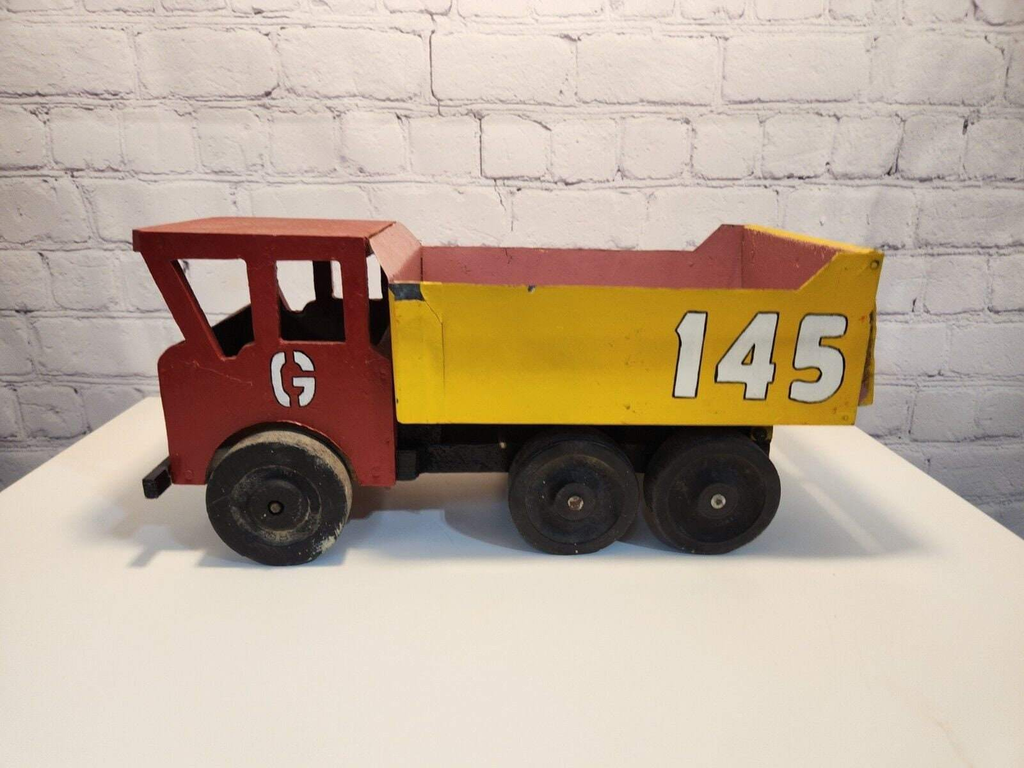 Vintage hand made toy truck  wood / metal dump truck  vintage handcrafThis vintage dump truck is a unique find for any collector or lover of handcrafted toys. Made of wood and metal, this truck was hand made in Canada in 1966. It is reChas Vintage ShopVintage hand made toy truck wood / metal dump truck vintage handcrafted toys