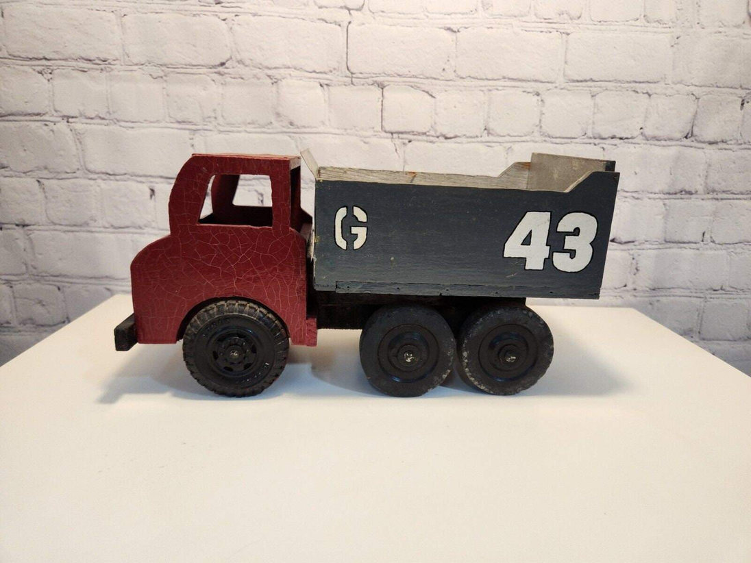 Vintage hand made toy truk  wood / metal dump truck  vintage handcraftThis vintage dump truck is a unique find for any collector or lover of handcrafted toys. Made of wood and metal, this truck was hand made in Canada in 1966. It is reChas Vintage ShopVintage hand made toy truk wood / metal dump truck vintage handcrafted toys