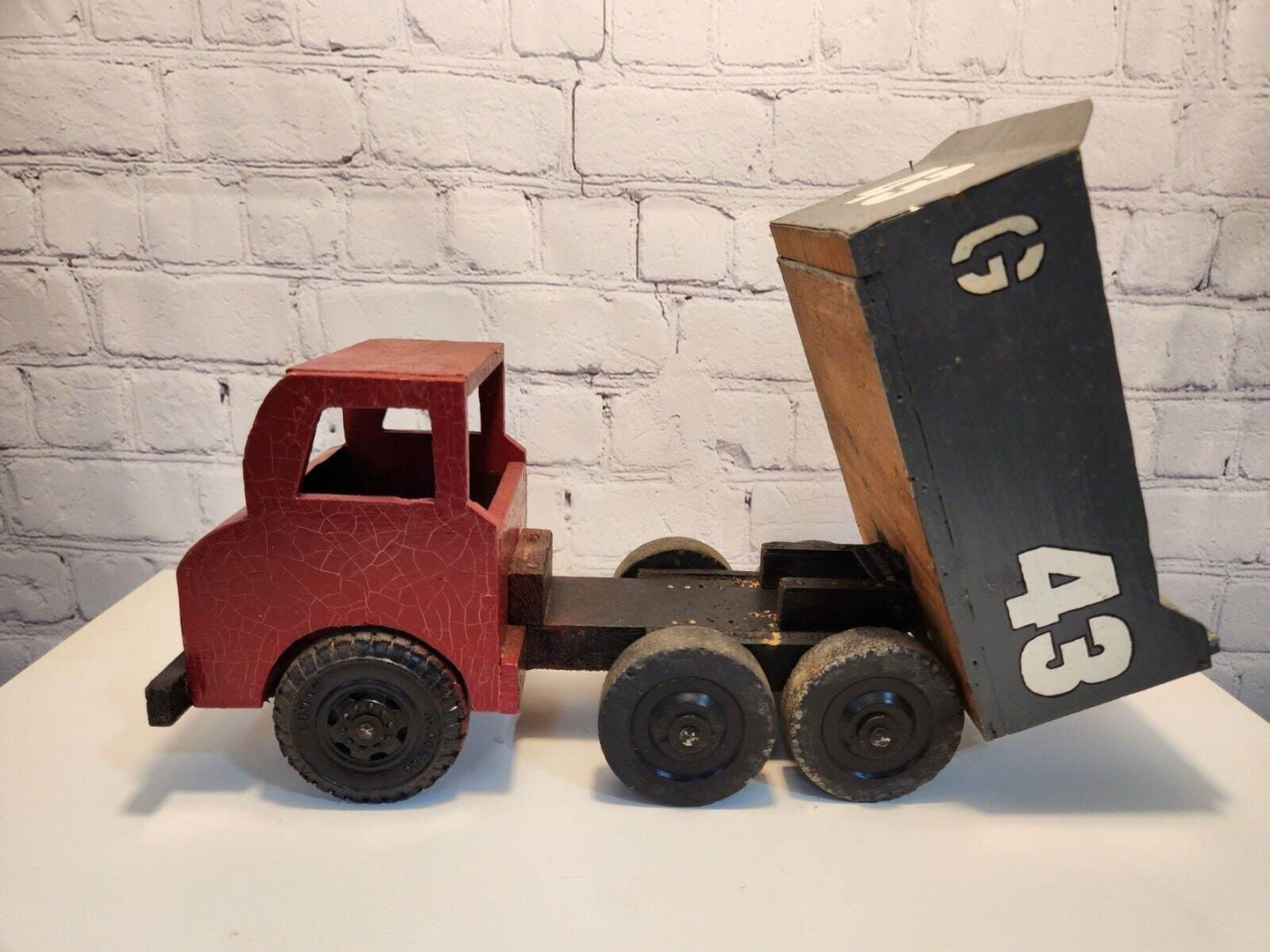 Vintage hand made toy truk  wood / metal dump truck  vintage handcraftThis vintage dump truck is a unique find for any collector or lover of handcrafted toys. Made of wood and metal, this truck was hand made in Canada in 1966. It is reChas Vintage ShopVintage hand made toy truk wood / metal dump truck vintage handcrafted toys