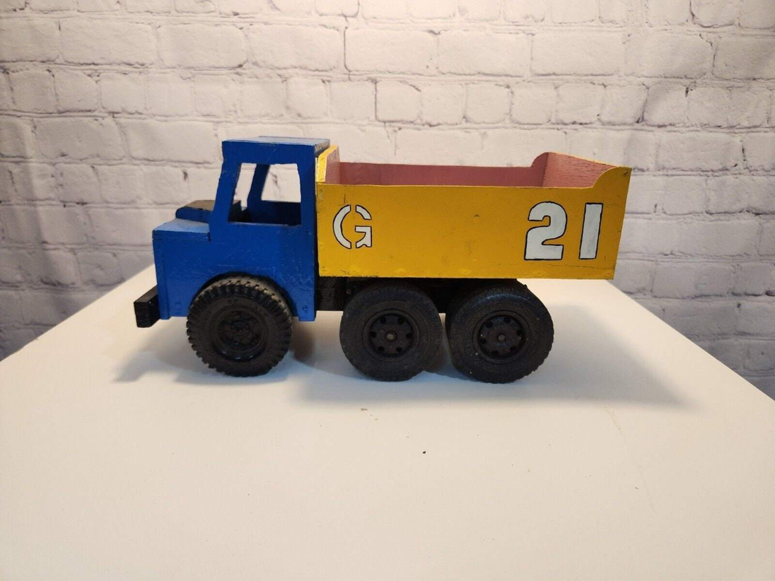 Vintage hand made toy truk  wood / metal dump truck  vintage handcraftThis vintage dump truck is a unique find for any collector or lover of handcrafted toys. Made of wood and metal, this truck was hand made in Canada in 1964. It is reChas Vintage ShopVintage hand made toy truk wood / metal dump truck vintage handcrafted toys