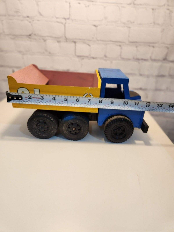 Vintage hand made toy truk  wood / metal dump truck  vintage handcraftThis vintage dump truck is a unique find for any collector or lover of handcrafted toys. Made of wood and metal, this truck was hand made in Canada in 1964. It is reChas Vintage ShopVintage hand made toy truk wood / metal dump truck vintage handcrafted toys