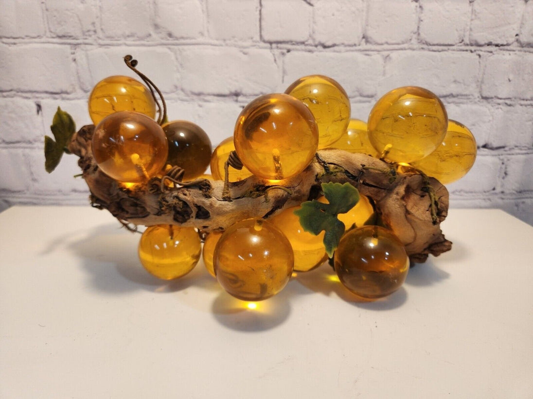 Vtg mcm cluster of large amber honey  lucite acrylic grapes  with plasThis vintage mid-century cluster of large amber honey lucite acrylic grapes with plastic leaves is a timeless piece of art that will add a touch of elegance to any sChas Vintage Shoplarge amber honey lucite acrylic grapes