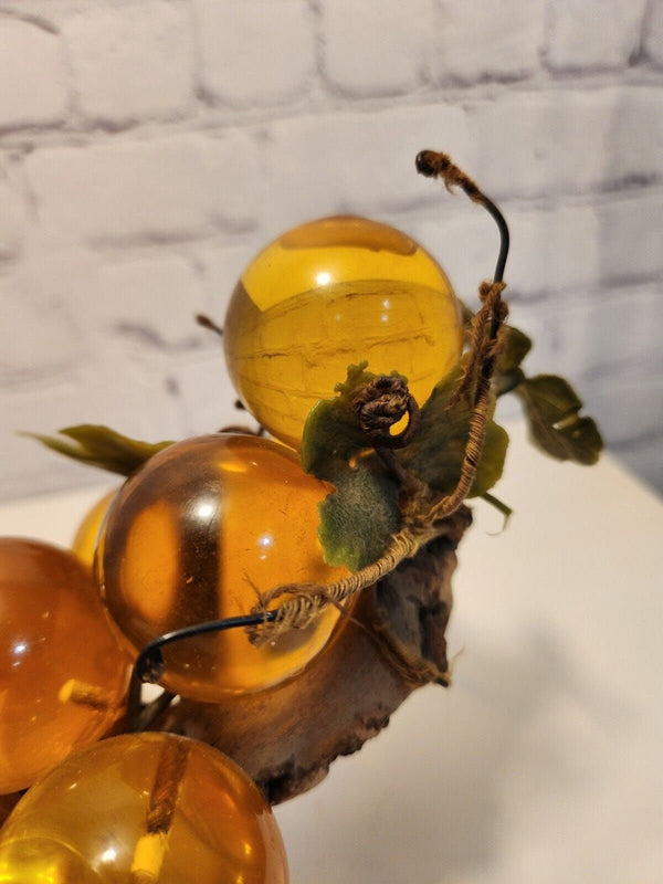 Vtg mcm cluster of large amber honey  lucite acrylic grapes  with plasThis vintage mid-century cluster of large amber honey lucite acrylic grapes with plastic leaves is a timeless piece of art that will add a touch of elegance to any sChas Vintage Shoplarge amber honey lucite acrylic grapes