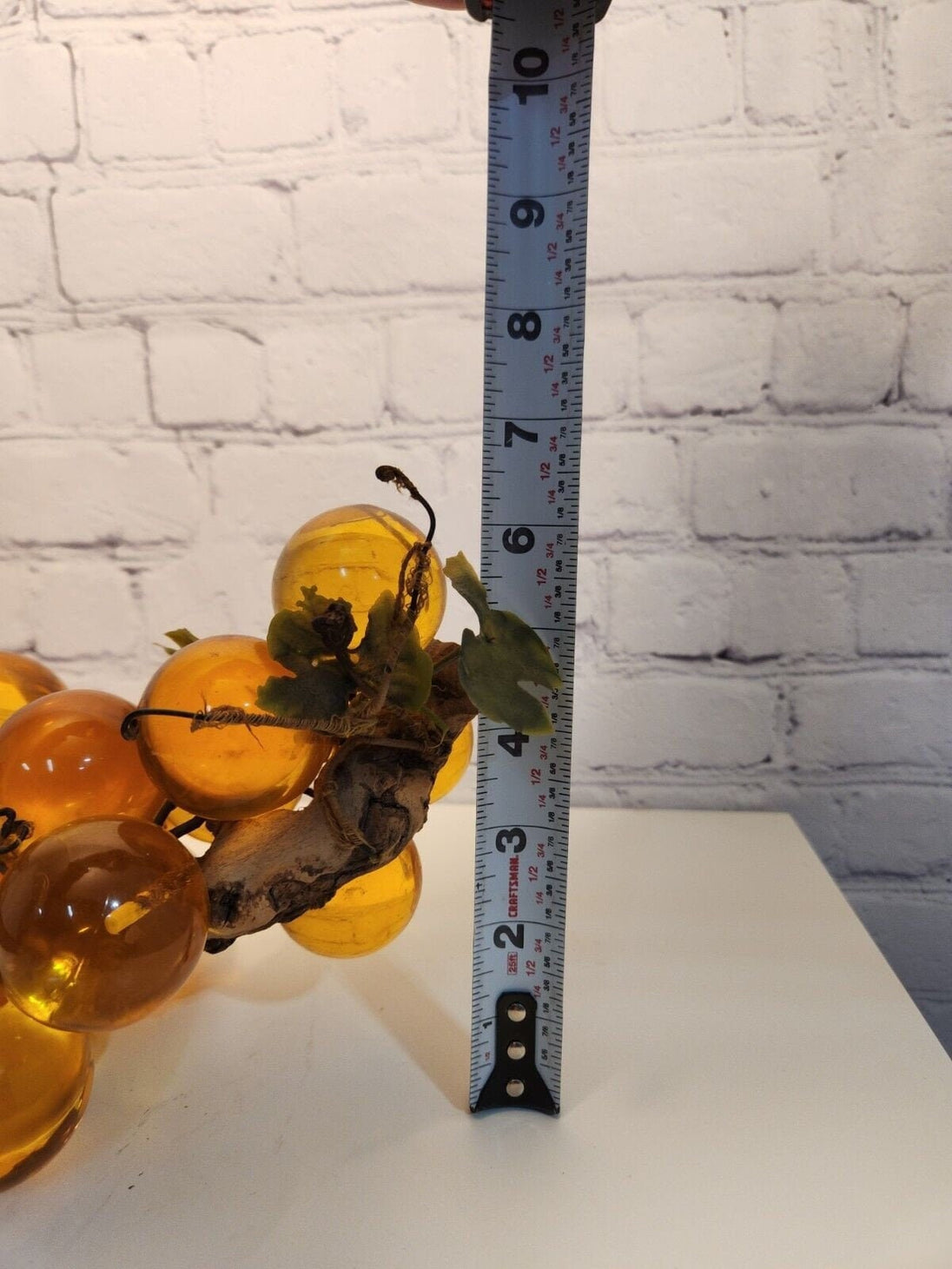 Vtg mcm cluster of large amber honey  lucite acrylic grapes  with plasThis vintage mid-century cluster of large amber honey lucite acrylic grapes with plastic leaves is a timeless piece of art that will add a touch of elegance to any sChas Vintage Shoplarge amber honey lucite acrylic grapes