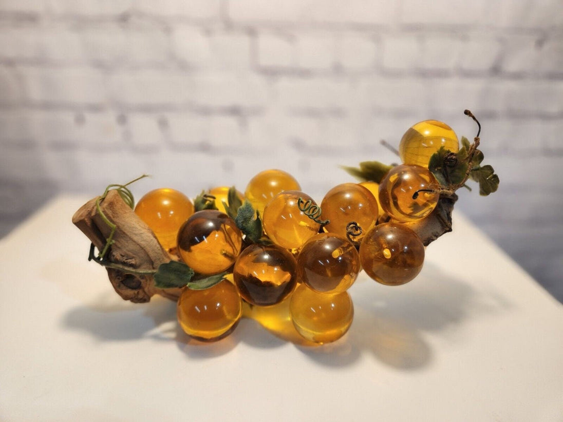 Vtg mcm cluster of large amber honey  lucite acrylic grapes  with plasThis vintage mid-century cluster of large amber honey lucite acrylic grapes with plastic leaves is a timeless piece of art that will add a touch of elegance to any sChas Vintage Shoplarge amber honey lucite acrylic grapes