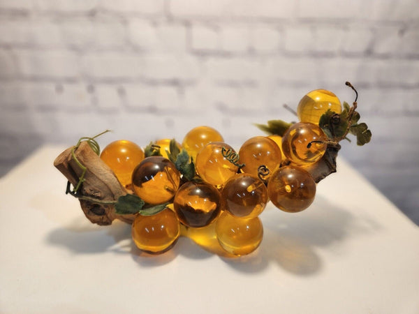 Vtg mcm cluster of large amber honey  lucite acrylic grapes  with plasThis vintage mid-century cluster of large amber honey lucite acrylic grapes with plastic leaves is a timeless piece of art that will add a touch of elegance to any sChas Vintage Shoplarge amber honey lucite acrylic grapes