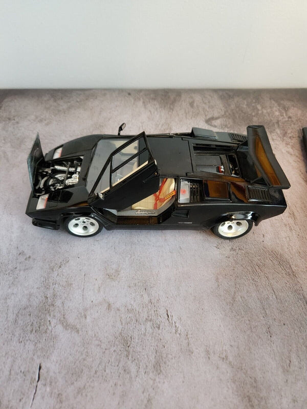 Black  burago lamborghini countach  1:18 die cast made in italyThis 1:18 scale diecast model of a 1988 Lamborghini Countach is a stunning addition to any car enthusiast's collection. Made by Burago, a renowned Italian brand, theChas Vintage ShopBlack burago lamborghini countach 1