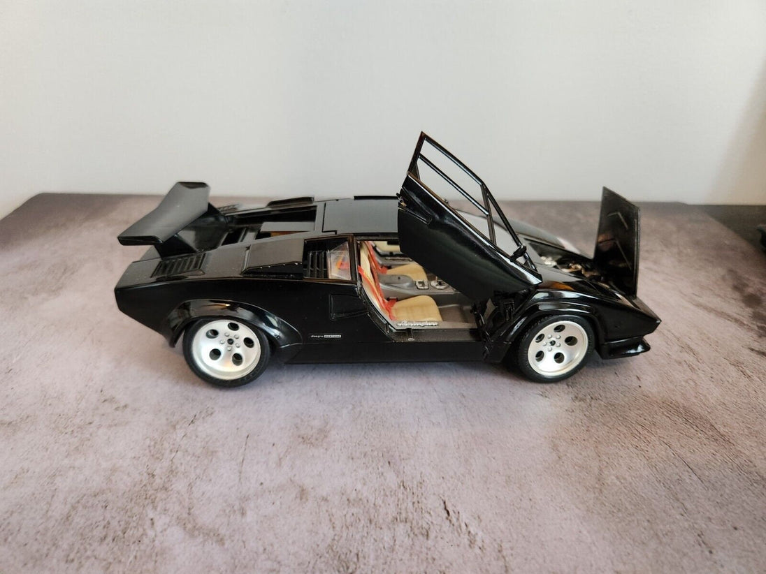 Black  burago lamborghini countach  1:18 die cast made in italyThis 1:18 scale diecast model of a 1988 Lamborghini Countach is a stunning addition to any car enthusiast's collection. Made by Burago, a renowned Italian brand, theChas Vintage ShopBlack burago lamborghini countach 1