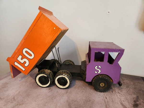 Vintage hand made wood and metal dump truck from 1966This vintage dump truck is a unique find for any collector or lover of handcrafted toys. Made of wood and metal, this truck was hand made in Canada in 1966. It is reChas Vintage ShopVintage hand made wood