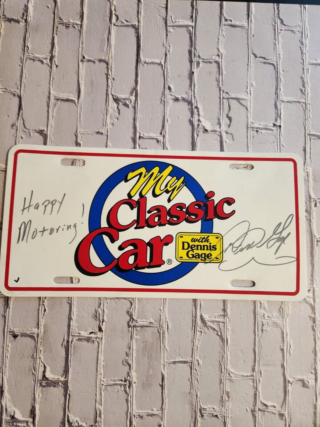 My classic car souvenir licence plate signed by dennis gage happy motoMy classic car souvenir licence plate signed by Dennis Gage Happy Motoring !This plasctic souvenir licence plate eas signed by Dennis Gage at some carevent. I have nChas Vintage Shopclassic car souvenir licence plate signed