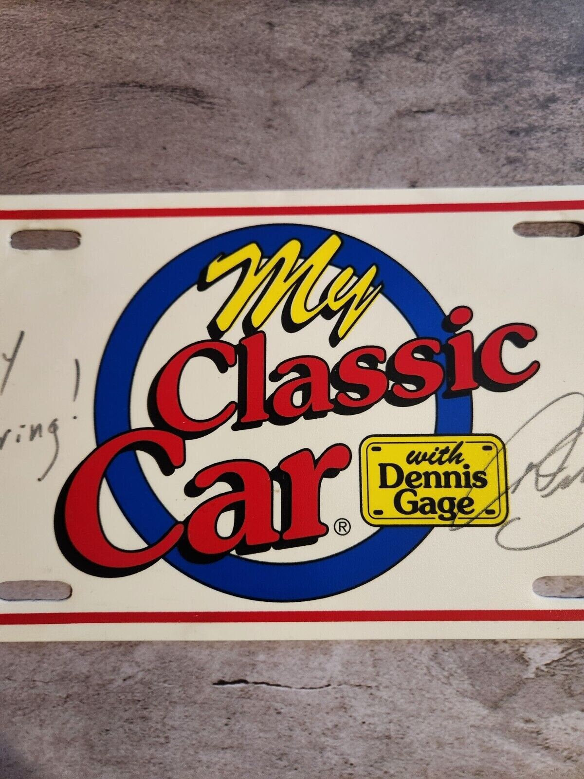 My classic car souvenir licence plate signed by dennis gage happy motoMy classic car souvenir licence plate signed by Dennis Gage Happy Motoring !This plasctic souvenir licence plate eas signed by Dennis Gage at some carevent. I have nChas Vintage Shopclassic car souvenir licence plate signed