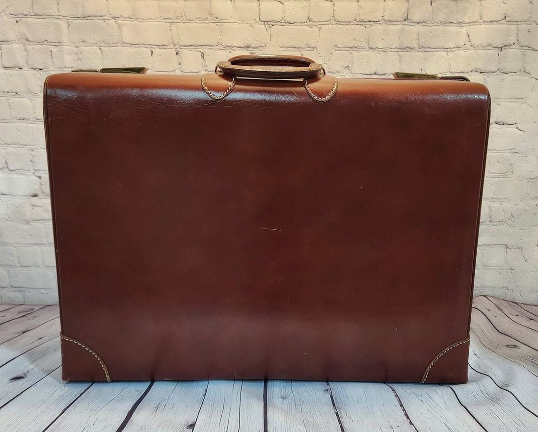 Vintage brown leather suitecase large size vintage suitcase  mid centuVintage brown leather suitecase Large size vintage suitcase Mid Centurysuitecase with protective canvas. Canada Cowhide vintage suitcaseThis vintage, heavy-duty, luxChas Vintage ShopVintage brown leather suitecase large size vintage suitcase mid century suitecase