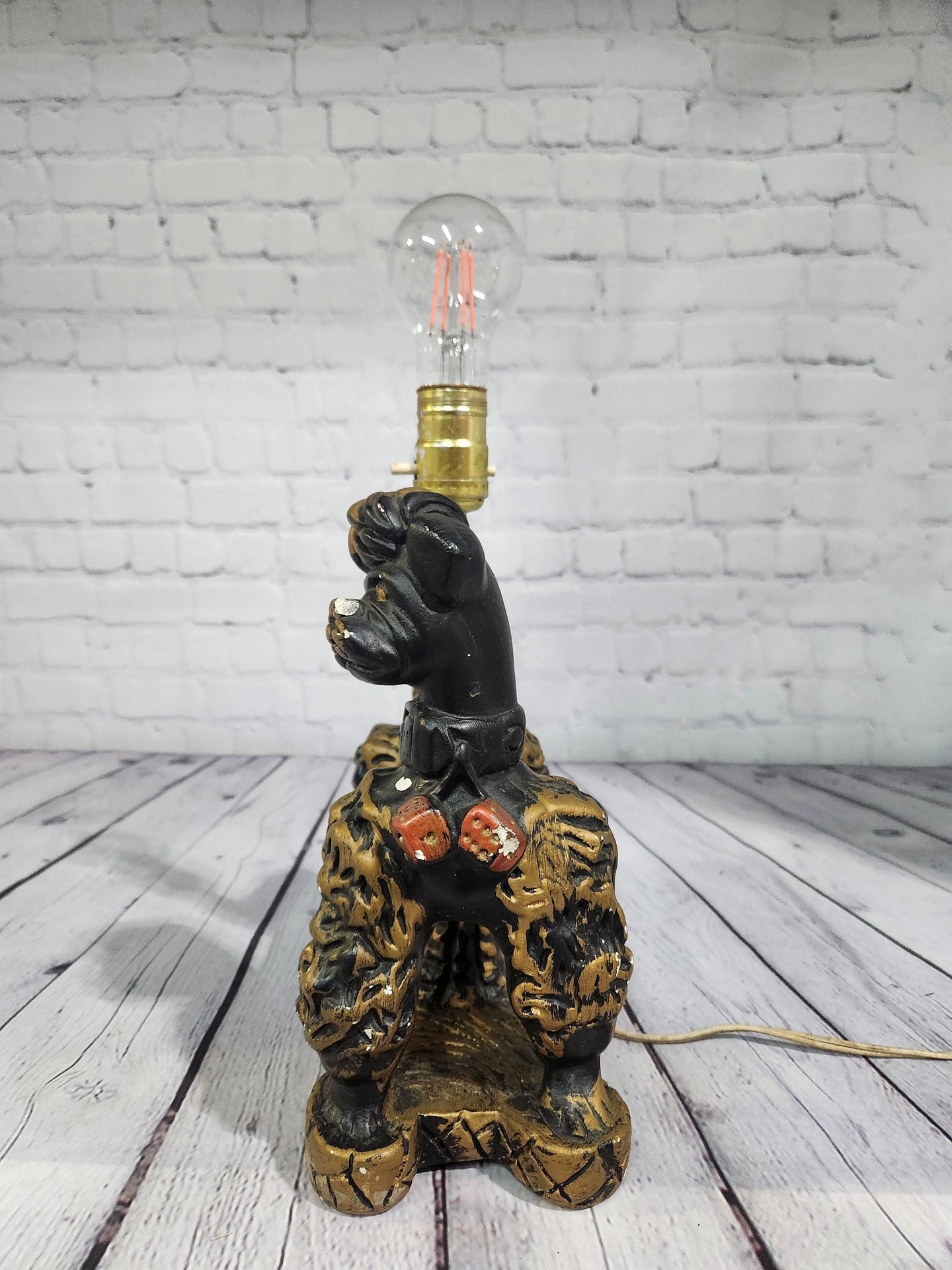 Kitsch poodle lamp rockabilly lamp vintage poodle lamp 1950's  kitsch Kitsch vintage poodle lamp rockabilly lamp in the shape of a poodle made in the50s /60
is 9 inches high by 12 inches long and 5 inches wideBlack and gold painted plaChas Vintage ShopKitsch poodle lamp rockabilly lamp vintage poodle lamp 1950'