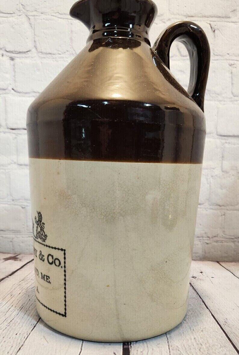 E. swasey co. portland maine 1 gallon brown beige  jug from 1800's earThis rare antique1 gallon jug from E. Swasey and CO is a true collector's item. This 1 gallon stoneware jug boasts a classic brown and beige colour scheme that exudeChas Vintage Shopportland maine 1 gallon brown beige jug