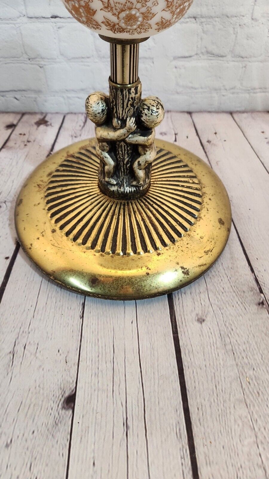 Mid century modern standing brass finish ashtray made in 60's  wtih 2 Mid century modern standing ashtray made in the 60'Brass finish with a globe in the middle and 2 Cherubs decorate the baseThis ashtray has a very elegant shape to itChas Vintage ShopMid century modern standing brass finish ashtray made